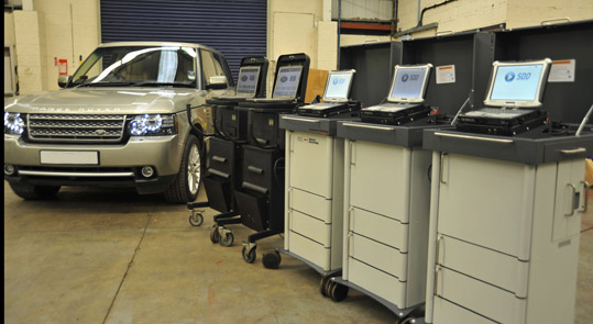 Land Rover Symptom Driven Diagnostic 2 (SDD2) worlshop next to car Land Rover Symptom Driven Diagnostic 2 (SDD2) workshop next to car